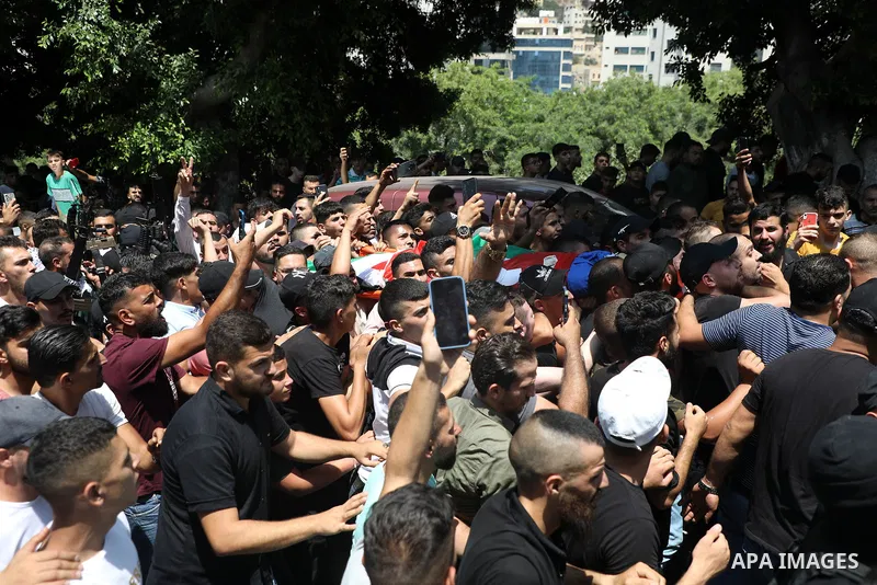 Mourners carry the bodies of Palestinian commander of the Al-Aqsa Martyrs' Brigade Ibrahim al-Nabulsi along with two of his comrades, who were killed in an Israeli raid, during a funeral procession in the West Bank city...