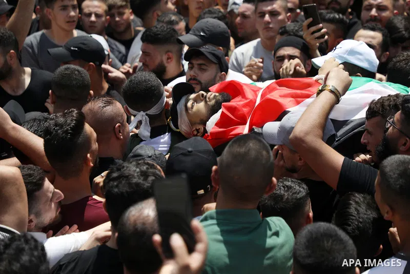 Mourners carry the bodies of Palestinian commander of the Al-Aqsa Martyrs' Brigade Ibrahim al-Nabulsi along with two of his comrades, who were killed in an Israeli raid, during a funeral procession in the West Bank city...