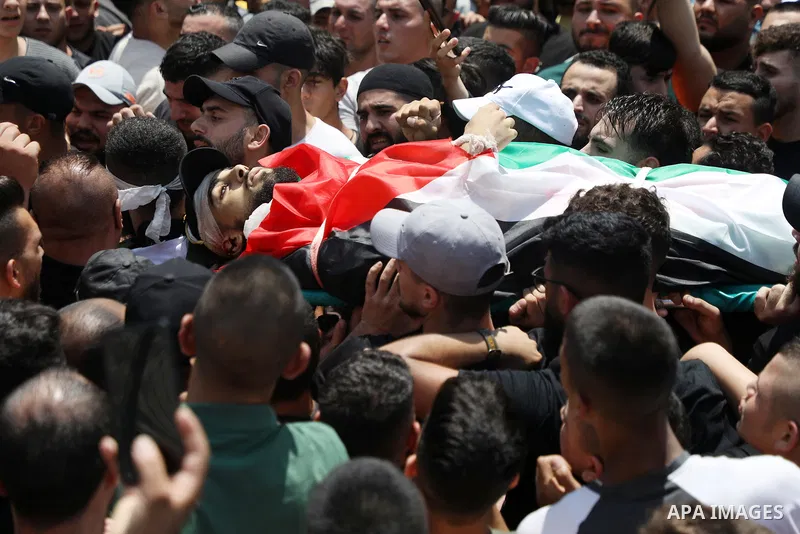 Mourners carry the bodies of Palestinian commander of the Al-Aqsa Martyrs' Brigade Ibrahim al-Nabulsi along with two of his comrades, who were killed in an Israeli raid, during a funeral procession in the West Bank city...