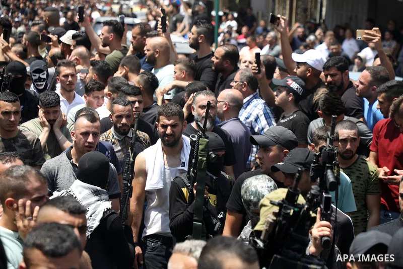Mourners attend the funeral of Palestinian commander of the Al-Aqsa Martyrs' Brigade Ibrahim al-Nabulsi along with two of his comrades, who was killed in an Israeli raid, in the West Bank city of Nablus on August 9, 2022...