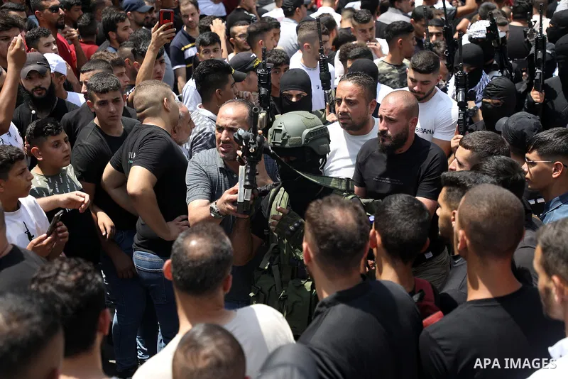 Mourners attend the funeral of Palestinian commander of the Al-Aqsa Martyrs' Brigade Ibrahim al-Nabulsi along with two of his comrades, who was killed in an Israeli raid, in the West Bank city of Nablus on August 9, 2022...