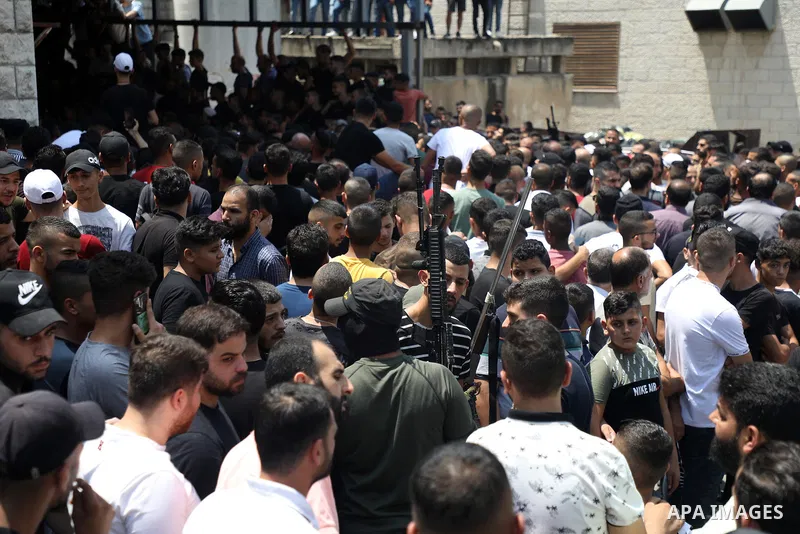 Mourners attend the funeral of Palestinian commander of the Al-Aqsa Martyrs' Brigade Ibrahim al-Nabulsi along with two of his comrades, who was killed in an Israeli raid, in the West Bank city of Nablus on August 9, 2022...