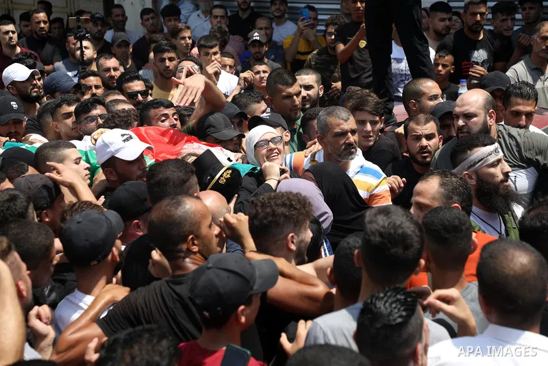Mother of Palestinian commander of the Al-Aqsa Martyrs' Brigade Ibrahim al-Nabulsi, who was killed in an Israeli raid, attends his funeral in the West Bank city of Nablus on August 9, 2022. Three people were killed and d...