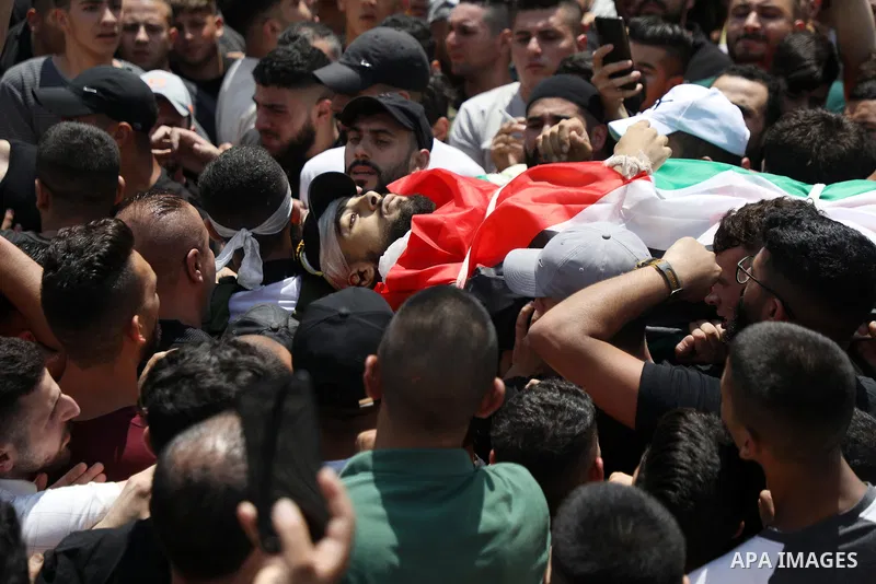 Mourners carry the bodies of Palestinian commander of the Al-Aqsa Martyrs' Brigade Ibrahim al-Nabulsi along with two of his comrades, who were killed in an Israeli raid, during a funeral procession in the West Bank city...