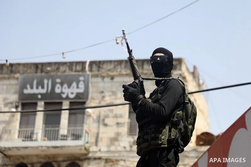 Mourners attend the funeral of Palestinian commander of the Al-Aqsa Martyrs' Brigade Ibrahim al-Nabulsi along with two of his comrades, who was killed in an Israeli raid, in the West Bank city of Nablus on August 9, 2022...
