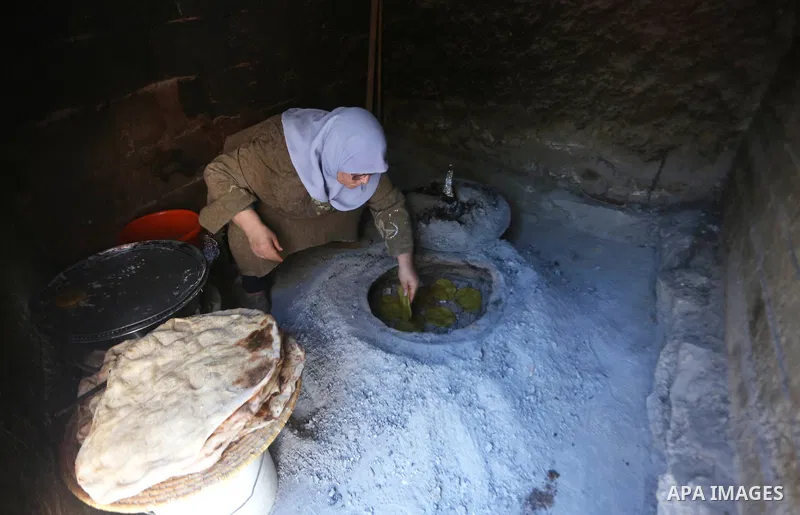 Palestinian woman Fatima Hammad, 57 prepares the traditional bread "Taboon", in town of Jama'in, south of the West Bank city of Nablus, on August 17, 2022. Taboon bread is Levantine flatbread baked in a taboon or tannur...