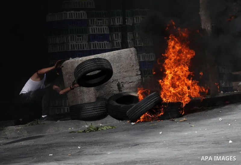 Clashes between Palestinian protesters and Israeli forces following a demonstration against settlement, in the West Bank city of Hebron on August 19, 2022. Photo by Mamoun Wazwaz