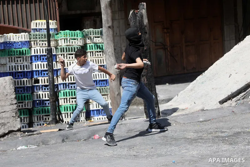 Clashes between Palestinian protesters and Israeli forces following a demonstration against settlement, in the West Bank city of Hebron on August 19, 2022. Photo by Mamoun Wazwaz