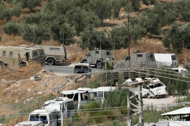 Palestinians hurl rocks at Israeli army vehicles during clashes in the town of Rujayb, east of the West Bank city of Nablus on August 30, 2022, after Palestinians opened fire at Israelis who snuck into the city. Palestin...