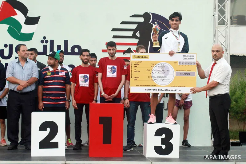 Palestinian runners participate in the Freedom Marathon on the occasion of Malaysian National Day, in Gaza city on August 31, 2022. Malaysia's Independence Day is celebrated on August 31st. Also known as Merdeka Day (Fre...