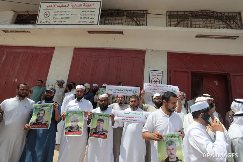 Palestinians take part in a protest in solidarity with prisoners on hunger strike in Israeli jails, in front of the headquarters of the Red Cross in Khan Yunis in the southern Gaza Strip on September 01, 2022. Palestinia...