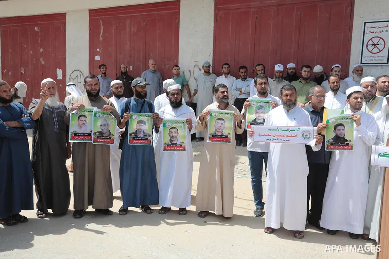 Palestinians take part in a protest in solidarity with prisoners on hunger strike in Israeli jails, in front of the headquarters of the Red Cross in Khan Yunis in the southern Gaza Strip on September 01, 2022. Palestinia...