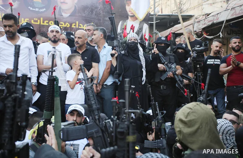 Palestinian militants hold their weapons during a memorial service of Mohammed al-Azizi and Abdul Rahman Sobh who were killed by Israeli forces on 24 July, in the West Bank city of Nablus on September 2, 2022. Photo by S...
