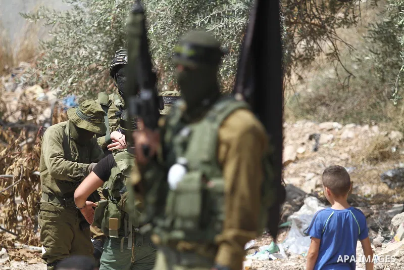 Mourners attend the funeral of 19 year-old Taher Zakarneh, who was killed during clashes with Israeli soldiers, in the Palestinian town of Qabatiya, near Jenin in the north of the Israeli-West Bank on September 5, 2022....