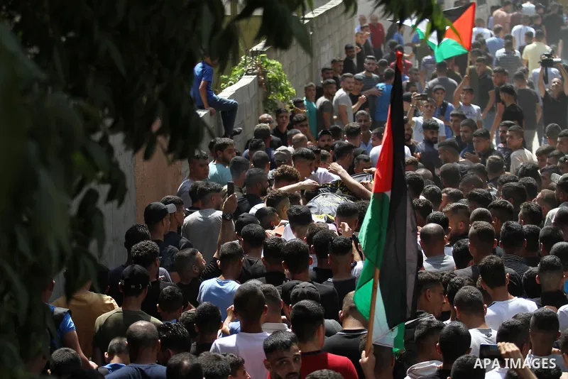 Mourners carry the body of 19 year-old Taher Zakarneh, who was killed during clashes with Israeli soldiers, during his funeral in the Palestinian town of Qabatiya, near Jenin in the north of the Israeli-West Bank on Sept...
