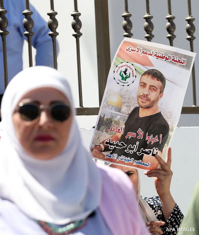 Palestinians take part in a protest in solidarity with cancer patient's prisoner Nasser Abu Hamid, in the West Bank city of Nablus on September 11, 2022. The Palestinian Prisoners and Ex-Prisoners Affairs Commission have...