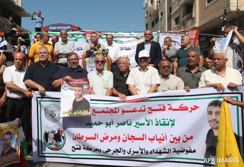 Palestinians take part in a protest in solidarity with prisoner in Israeli jails suffering from cancer Nasser Abu Hamid, in front of Red cross office, in Gaza city on September 15, 2022. As cancer-stricken prisoner Nasse...