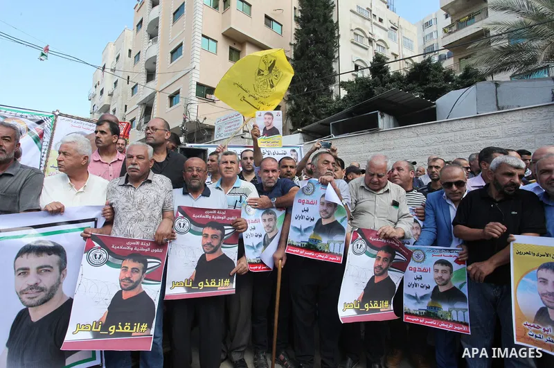 Palestinians take part in a protest in solidarity with prisoner in Israeli jails suffering from cancer Nasser Abu Hamid, in front of Red cross office, in Gaza city on September 15, 2022. As cancer-stricken prisoner Nasse...