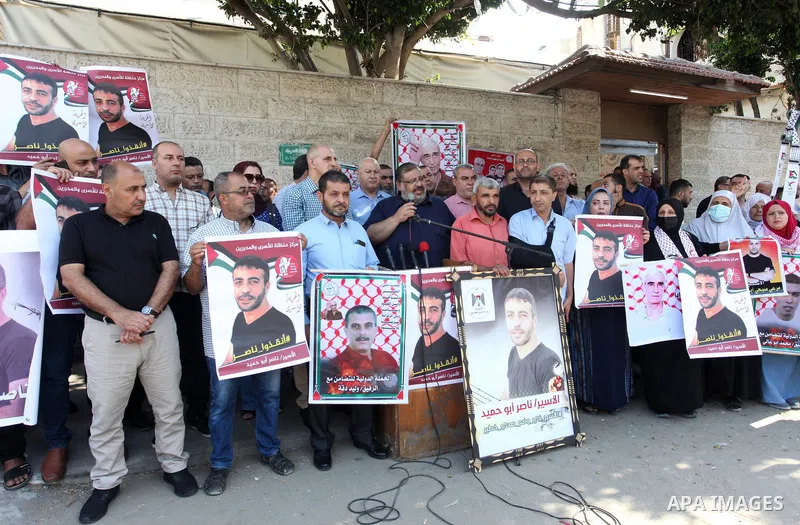 Palestinians take part in a protest in solidarity with prisoners on hunger strike in Israeli Jails in front of the headquarters of the Red Cross in Gaza City, on September 19, 2022. Israel’s widely condemned policy of ad...