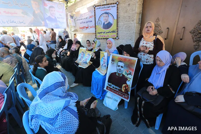 Palestinians take part in a protest in solidarity with a cancer sick prisoner Nasser Abu Hamid at Israeli jails, in front of Red Cross office in Gaza city on September 29, 2022. Hundreds of Palestinians marched today dem...