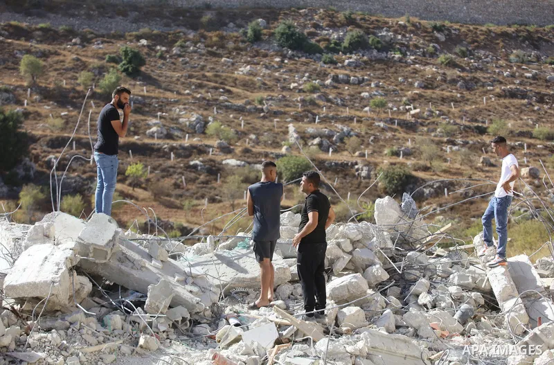 Palestinians inspect the rubble of houses which were demolished by the Israeli army in the village of Artas, to the south of the West Bank city of Bethlehem, on September 29, 2022. Israeli forces raided the area of Sulei...