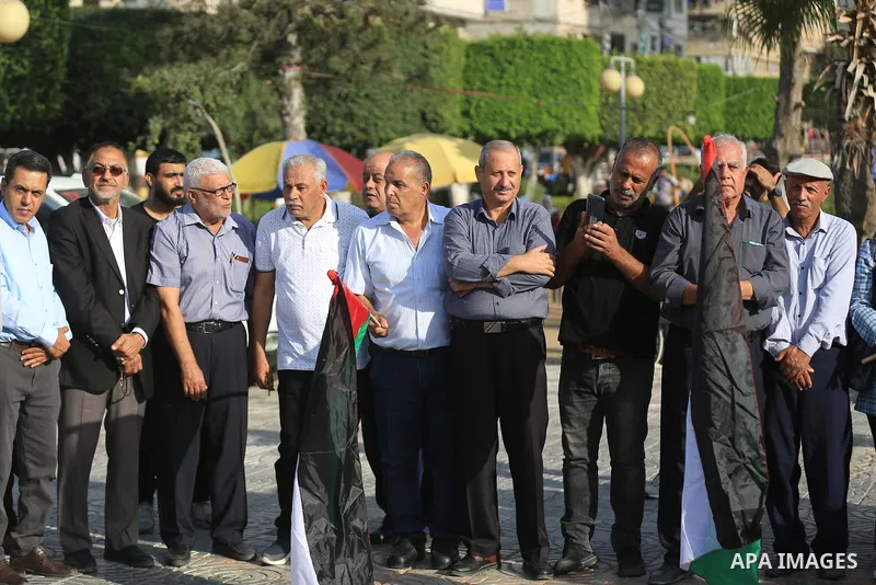 Palestinians take part in a protest in solidarity with Shuafat refugee camp aginst the continuing of the Israeli closed of the camp in Gaza city on October 12, 2022. Israeli forces are continuing a manhunt for a gunman o...