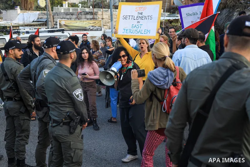 Protesters raise placards and Palestinian flags during a rally organised by foreign and Palestinian activists in the Israeli-annexed east Jerusalem neighbourhood of Sheikh Jarrah, to denounce a years-long bid by Jewish s...