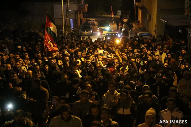 Mourners carry the body of Palestinian Mohammed Badarneh who was shot killed by Israeli forces during his funeral, in the West Bank city of Jenin on November 30, 2022. A Palestinian identified as Mohammad Tawfiq Badarna,...