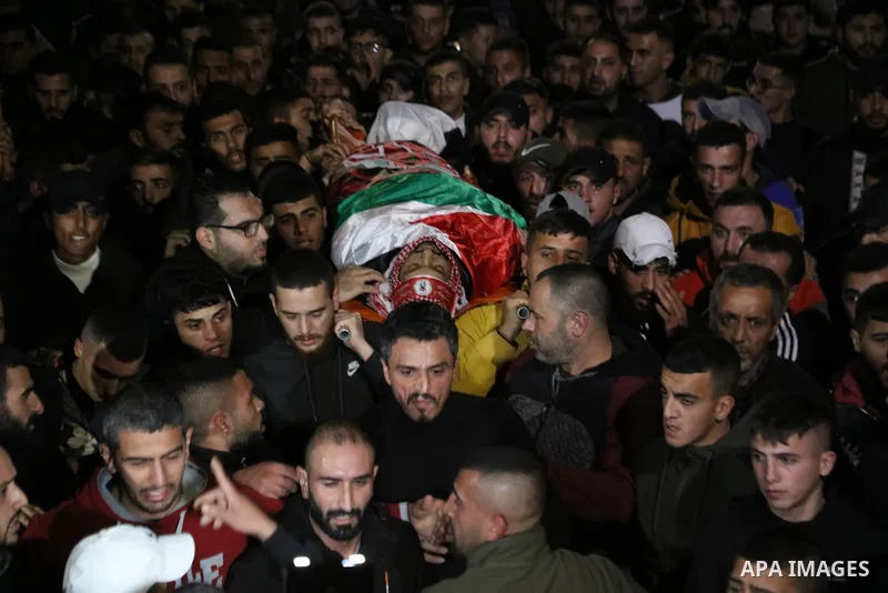 Mourners carry the body of Palestinian Mohammed Badarneh who was shot killed by Israeli forces during his funeral, in the West Bank city of Jenin on November 30, 2022. A Palestinian identified as Mohammad Tawfiq Badarna,...