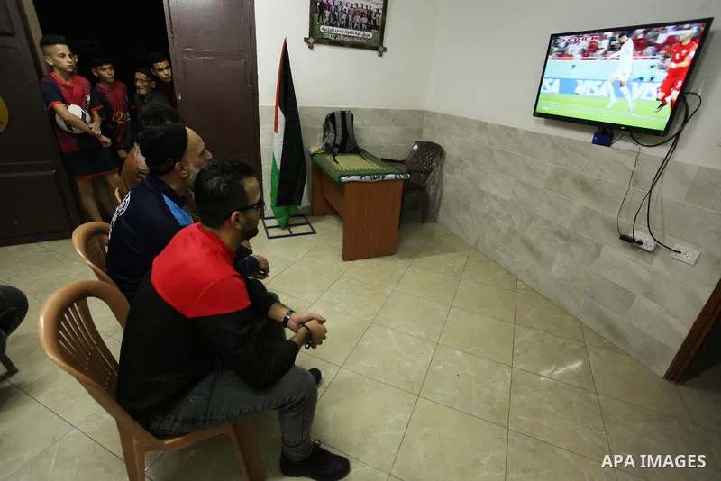 Palestinians listen to TV during the match between Morocco VS Canada, in the Qatar World Cup FIFA 2022, in Gaza city on December 1, 2022. There are at least 130,000 Palestinian people aged 50 years and older who live wit...