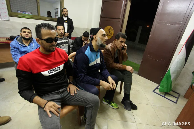 Palestinians listen to TV during the match between Morocco VS Canada, in the Qatar World Cup FIFA 2022, in Gaza city on December 1, 2022. There are at least 130,000 Palestinian people aged 50 years and older who live wit...