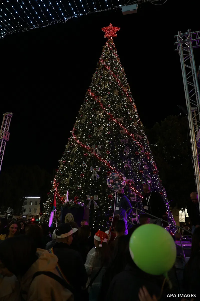 Palestinians light Christmas tree in Manger Square outside the Church of the Nativity in the West Bank city of Bethlehem on December 3, 2022. Christmas is an annual festival commemorating the birth of Jesus Christ, obser...