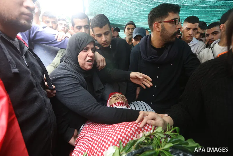 Palestinians carry the body of Omar Manaa, 22, shot dead by Israeli forces amid clashes earlier during a raid, at his funeral in the Dheisheh refugee camp near the West Bank city of Bethlehem, on December 5, 2022. Photo...