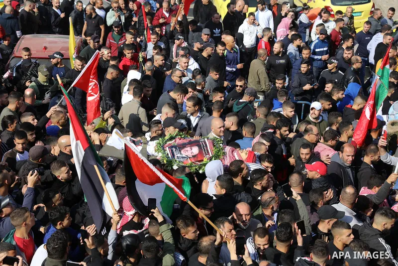Palestinians carry the body of Omar Manaa, 22, shot dead by Israeli forces amid clashes earlier during a raid, at his funeral in the Dheisheh refugee camp near the West Bank city of Bethlehem, on December 5, 2022. Photo...