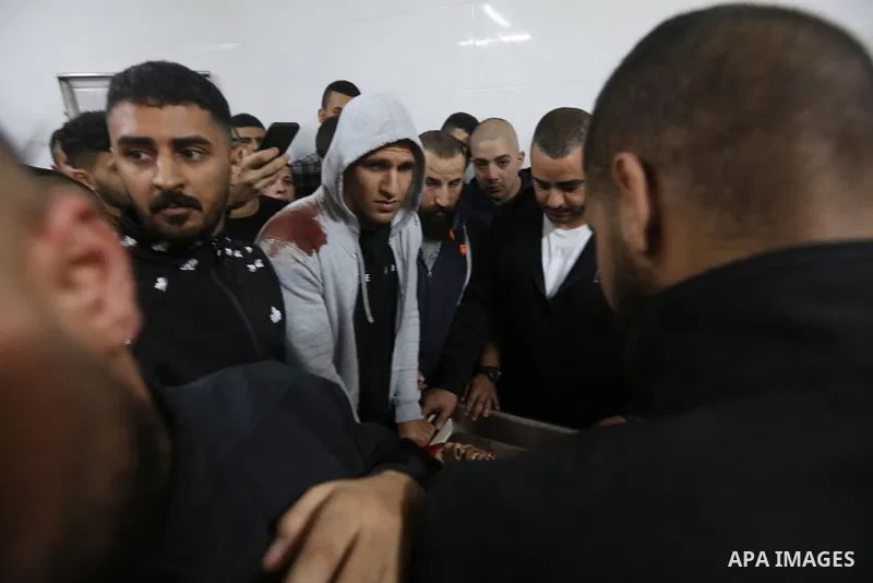 Palestinians carry the body of Omar Manaa, 22, shot dead by Israeli forces amid clashes earlier during a raid, at his funeral in the Dheisheh refugee camp near the West Bank city of Bethlehem, on December 5, 2022. Photo...