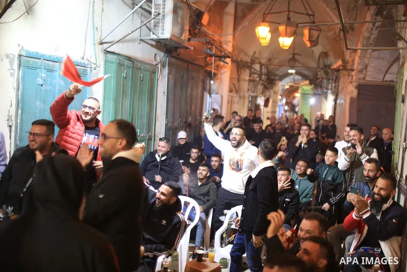 Palestinian fans gather to attend Morocco vs Portugal match in the Bashoura Market, one of the markets in the Old City of Jerusalem on December 10, 2022. Photo by Saeed Qaq\ apaimages