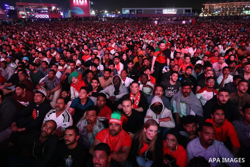 Fans attend on a huge screen the semi-final match between Morocco and France on the Doha Corniche on December 14, 2022. The 2022 FIFA World Cup is an association football tournament, contested by the men's national teams...
