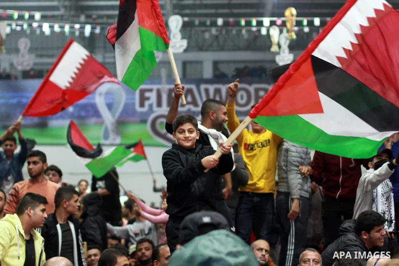 Palestinian football fans react as they watch on a large screen the Qatar World Cup 2022 semi-final football match between Morocco and France, in Gaza city on December 14, 2022. Photo by Ali Hamad\ apaimages