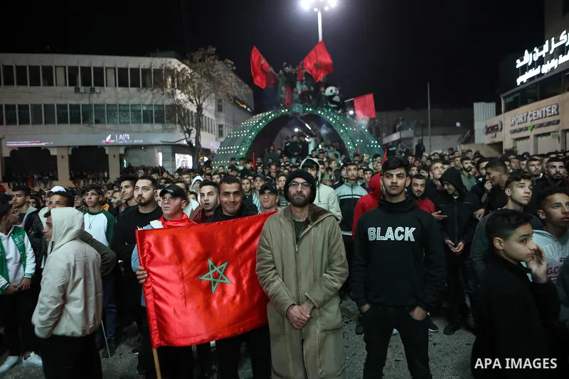 Palestinian football fans react as they watch on a large screen the Qatar World Cup 2022 semi-final football match between Morocco and France, in the West Bank city of Hebron on December 14, 2022. Photo by Mamoun Wazwaz/...