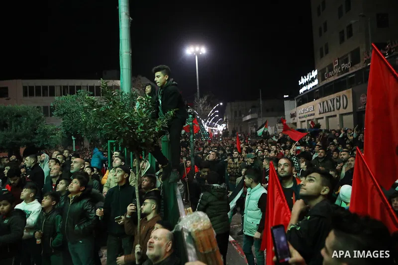 Palestinian football fans react as they watch on a large screen the Qatar World Cup 2022 semi-final football match between Morocco and France, in the West Bank city of Hebron on December 14, 2022. Photo by Mamoun Wazwaz/...