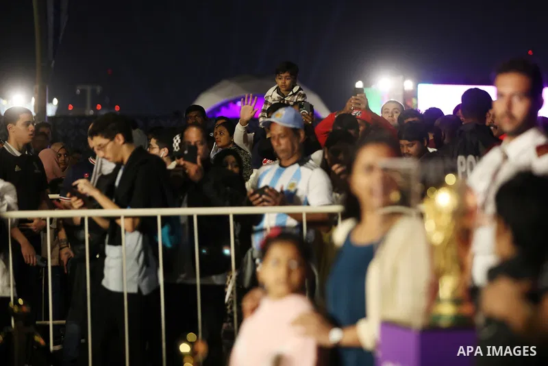 Football fans take photo with original version of World trophy during the FIFA World Cup Qatar 2022 on the Doha Corniche, in Qatar on December 15, 2022. The 2022 FIFA World Cup is an association football tournament, cont...
