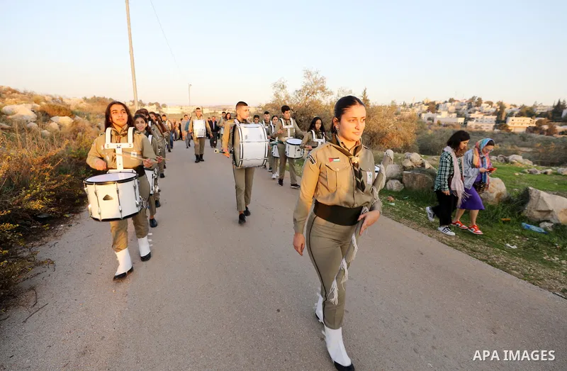 Christian worshippers take part in a procession towards the Church of Saint Barbara in the village of Aboud in the West Bank, on December 16, 2022, on the eve of Saint Barbara's Day. Photo by Wajed Nobani