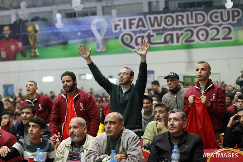 Palestinian football fans react as they watch on a large screen the Qatar World Cup 2022 Third-Place Playoff match between Morocco and Croatia, in Gaza city on December 17, 2022. Photo by Ali Hamad