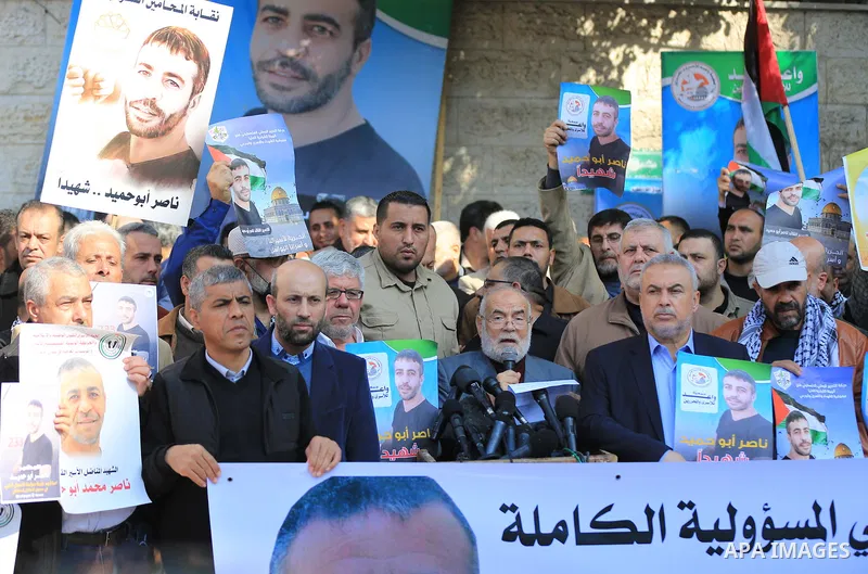 Palestinians take part in a protest following the death of prisoner Nasser Abu Hamid, in front of Red Cross office, in Gaza city, on December 20, 2022. Abu Hmeid, who entered into a coma two days ago and was yesterday tr...