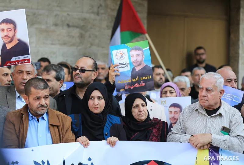 Palestinians take part in a protest following the death of prisoner Nasser Abu Hamid, in front of Red Cross office, in Gaza city, on December 20, 2022. Abu Hmeid, who entered into a coma two days ago and was yesterday tr...