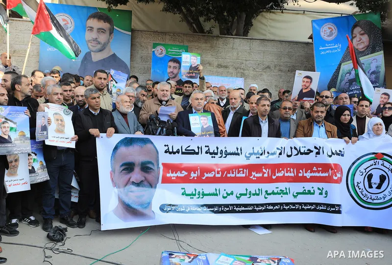 Palestinians take part in a protest following the death of prisoner Nasser Abu Hamid, in front of Red Cross office, in Gaza city, on December 20, 2022. Abu Hmeid, who entered into a coma two days ago and was yesterday tr...
