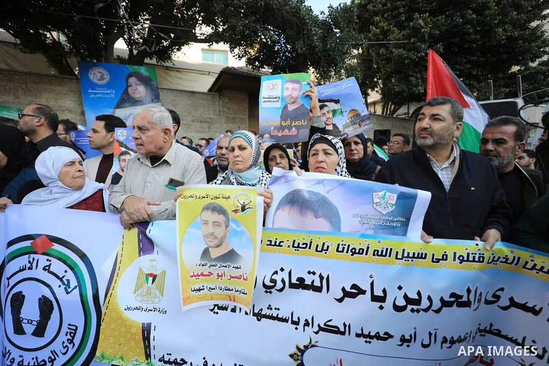 Palestinians take part in a protest following the death of prisoner Nasser Abu Hamid, in front of Red Cross office, in Gaza city, on December 20, 2022. Abu Hmeid, who entered into a coma two days ago and was yesterday tr...