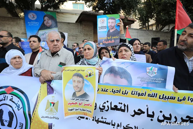 Palestinians take part in a protest following the death of prisoner Nasser Abu Hamid, in front of Red Cross office, in Gaza city, on December 20, 2022. Abu Hmeid, who entered into a coma two days ago and was yesterday tr...