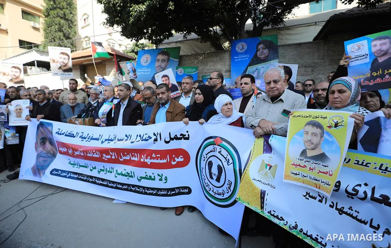 Palestinians take part in a protest following the death of prisoner Nasser Abu Hamid, in front of Red Cross office, in Gaza city, on December 20, 2022. Abu Hmeid, who entered into a coma two days ago and was yesterday tr...