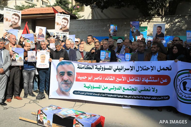 Palestinians take part in a protest following the death of prisoner Nasser Abu Hamid, in front of Red Cross office, in Gaza city, on December 20, 2022. Abu Hmeid, who entered into a coma two days ago and was yesterday tr...